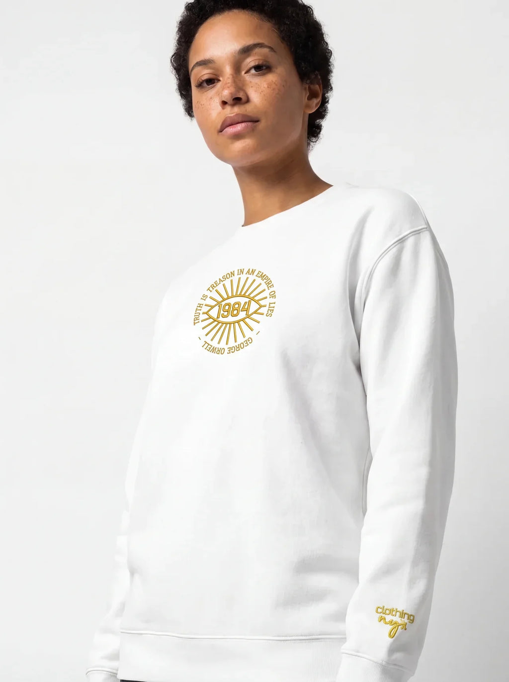 Model wearing the Truth is treason embroidered sweatshirt in Navy, café